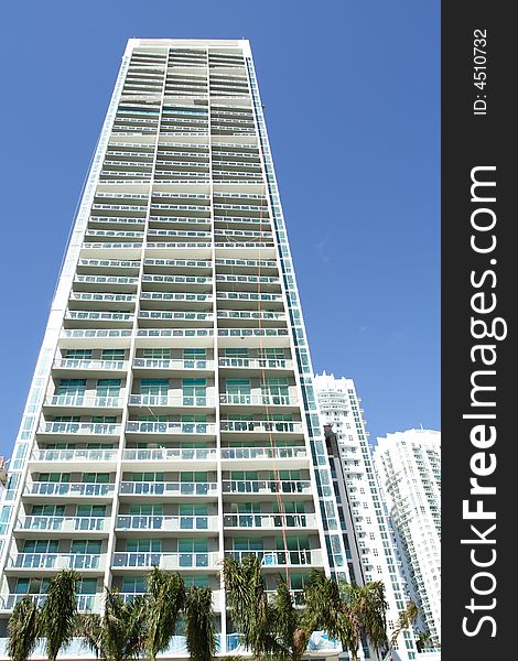 Modern abstract condominium building on a blue sky. Modern abstract condominium building on a blue sky