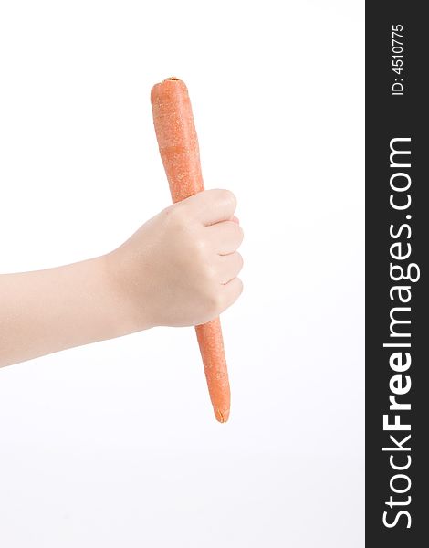 A carrot in the hand of a child