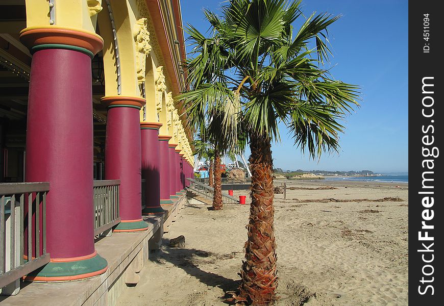 Brightly colored pavilllian on the beach boardwalk, closeup of pillars and arches.