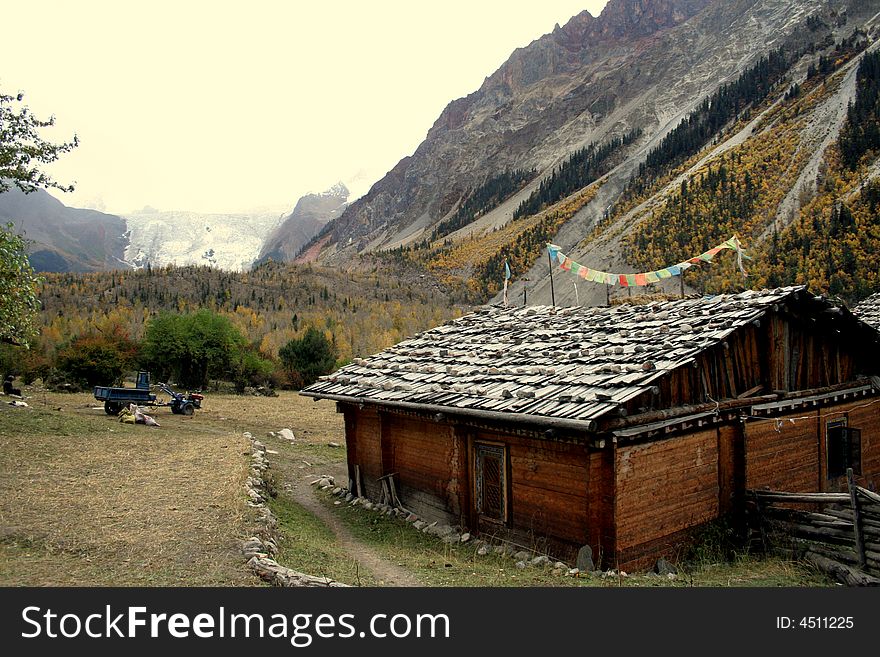 At the entrance of Midui glacier - a tibet house in the autumn valley. At the entrance of Midui glacier - a tibet house in the autumn valley