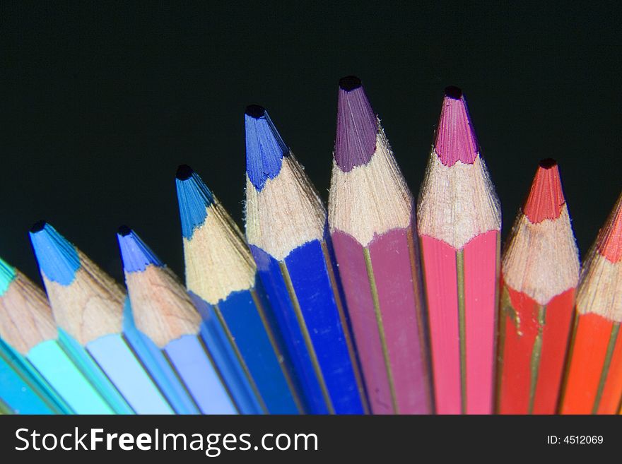 A bunch of color pencil with black background. A bunch of color pencil with black background.