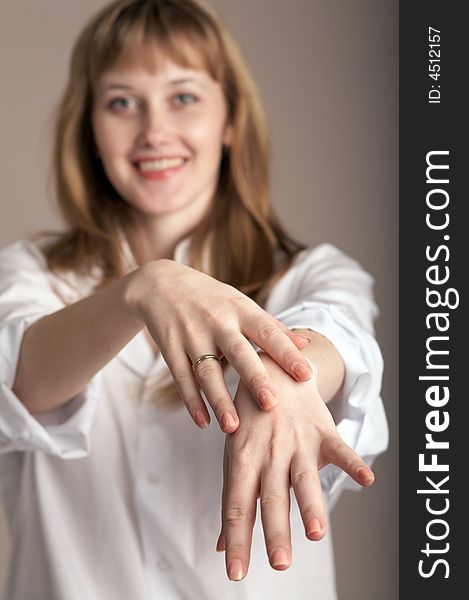 An image of  woman in white shirt showing her hands