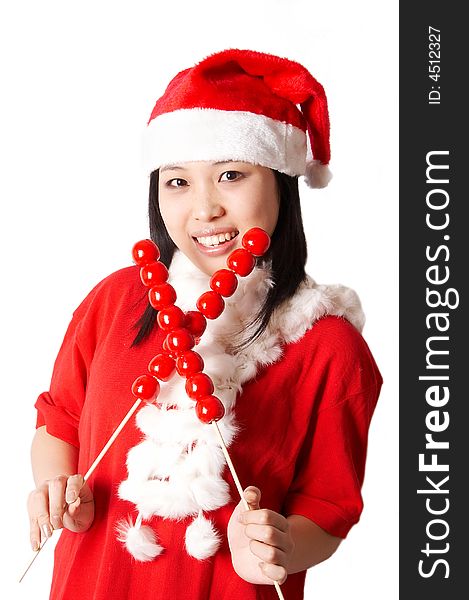 Beautiful asian Santa Claus girl smiling and holding traditional food Tanghulu isolated on white. Beautiful asian Santa Claus girl smiling and holding traditional food Tanghulu isolated on white