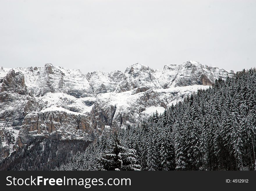 Snowy mountains on cloudy winter day in Italian Dolomites. Snowy mountains on cloudy winter day in Italian Dolomites