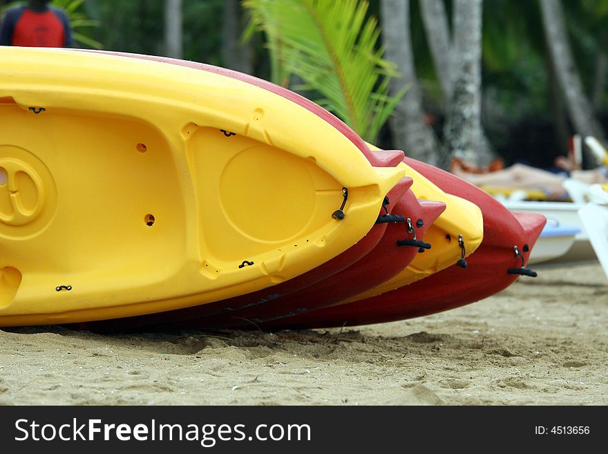 Colorful kayaks lying on the sand beach. Colorful kayaks lying on the sand beach