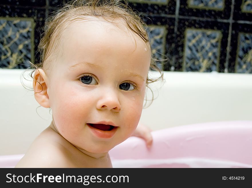 Bathing and smiling baby looking at camera. Bathing and smiling baby looking at camera