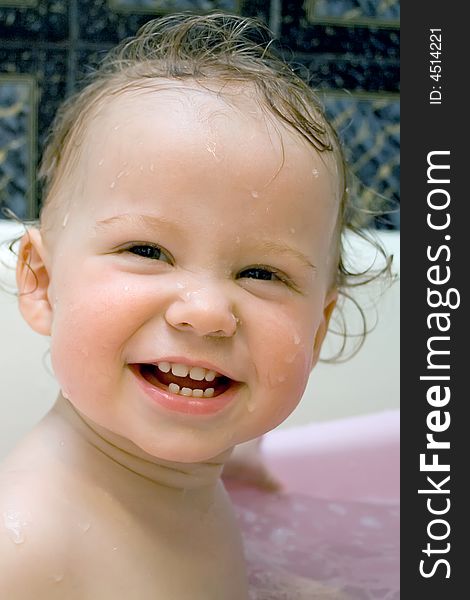 Bathing and smiling baby looking at camera. Bathing and smiling baby looking at camera