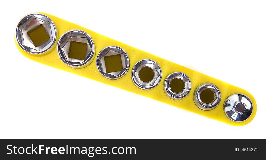 A set of sockets in a yellow holder isolated on white. A set of sockets in a yellow holder isolated on white