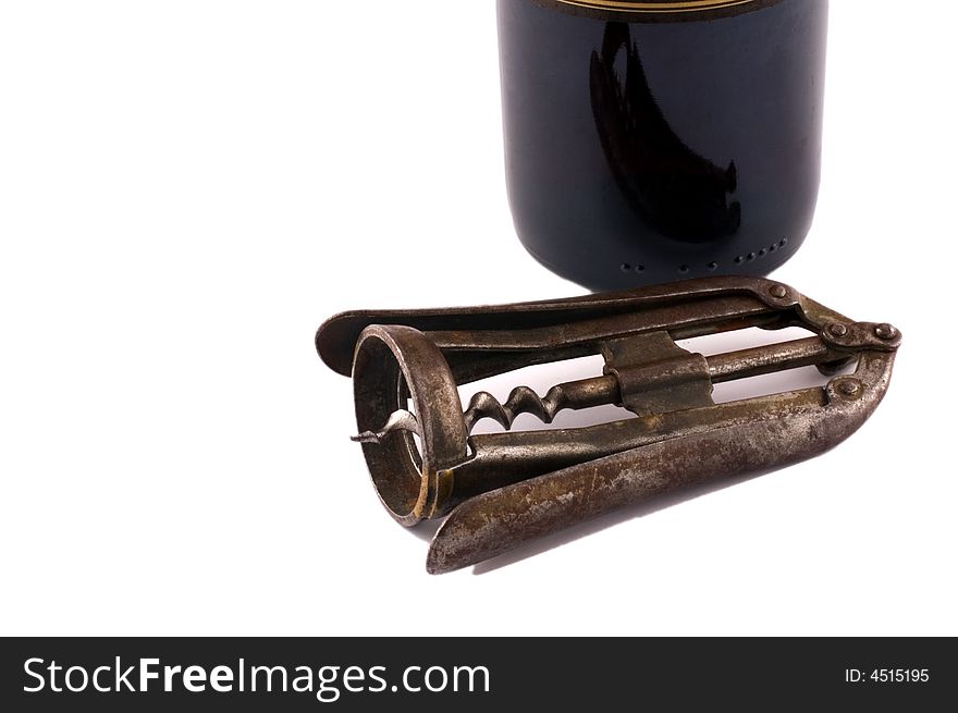 Corkscrew near bottle isolated on white with selective focus