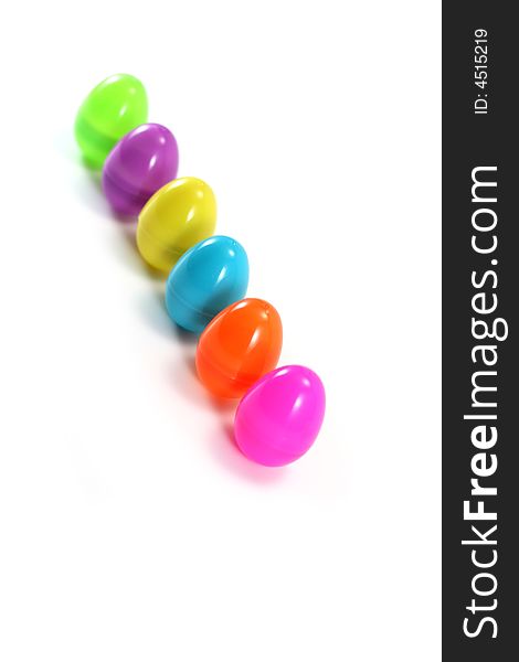 A line of pastel Easter eggs on white background