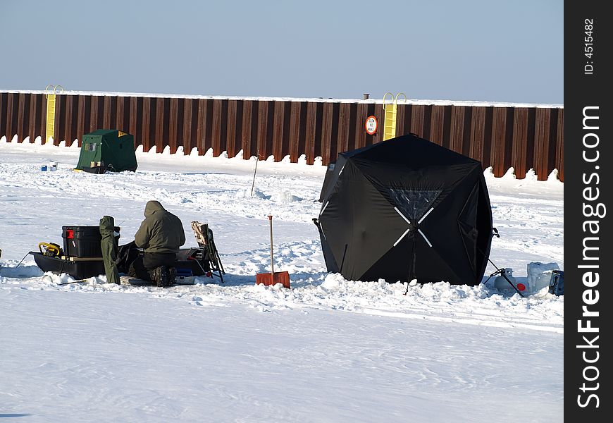 Ice fishing on Michigan lake.