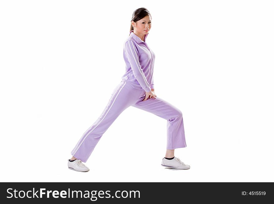 Woman doing exercise by bending one leg side ways