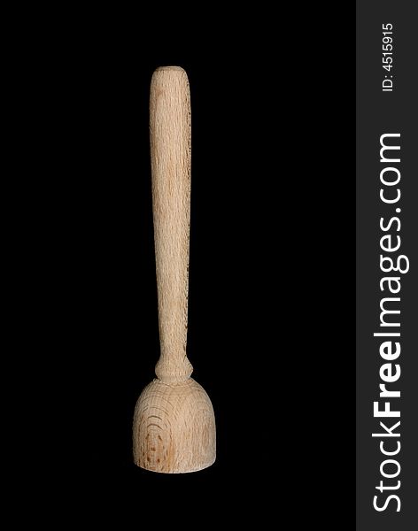 A toy wooden utensil isolated on black.