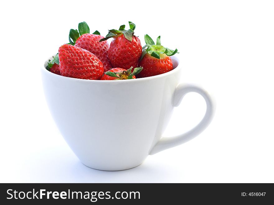 Strawberry on white background inside white cup