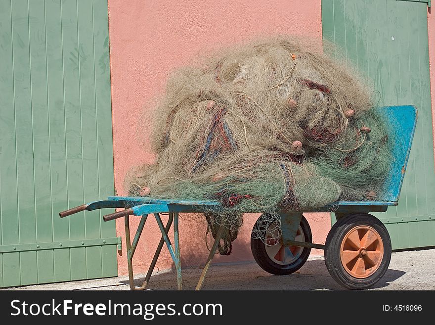 Fishing net to fish posed on the quay