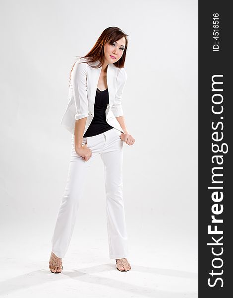 Young business woman in white pants and white jacket expressing herself. Young business woman in white pants and white jacket expressing herself
