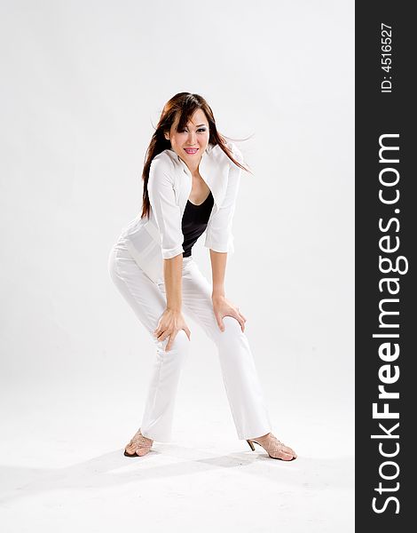 Young woman in white pants and white jacket expressing herself. Young woman in white pants and white jacket expressing herself