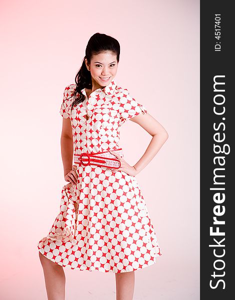 Girl in a red dress with white dots with an expressive face and gesture. Girl in a red dress with white dots with an expressive face and gesture