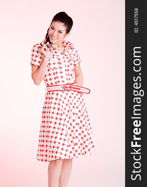 Girl in a red dress with white dots with an expressive face and gesture. Girl in a red dress with white dots with an expressive face and gesture