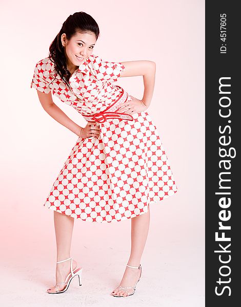 Girl in a red dress with white dots with an expressive face and gesture. Girl in a red dress with white dots with an expressive face and gesture