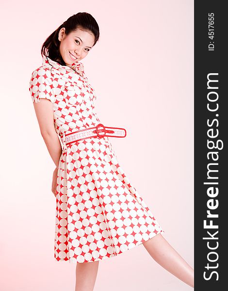 Girl in a red dress with white dots with an expressive face and gesture. Girl in a red dress with white dots with an expressive face and gesture