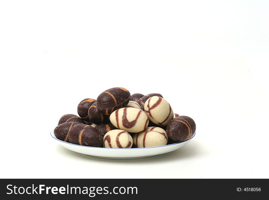 Saucer with milk chocolate and dark chocolate eggs