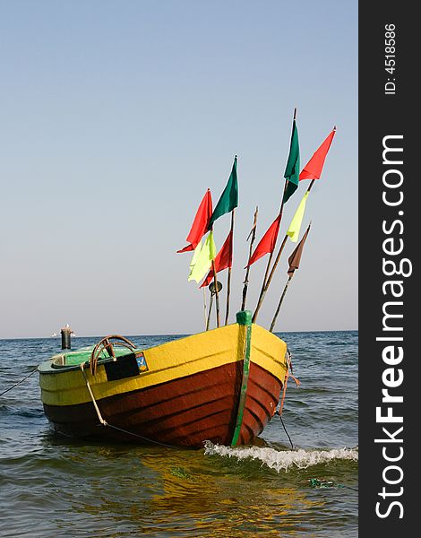 Fisherman boat with flags in sea