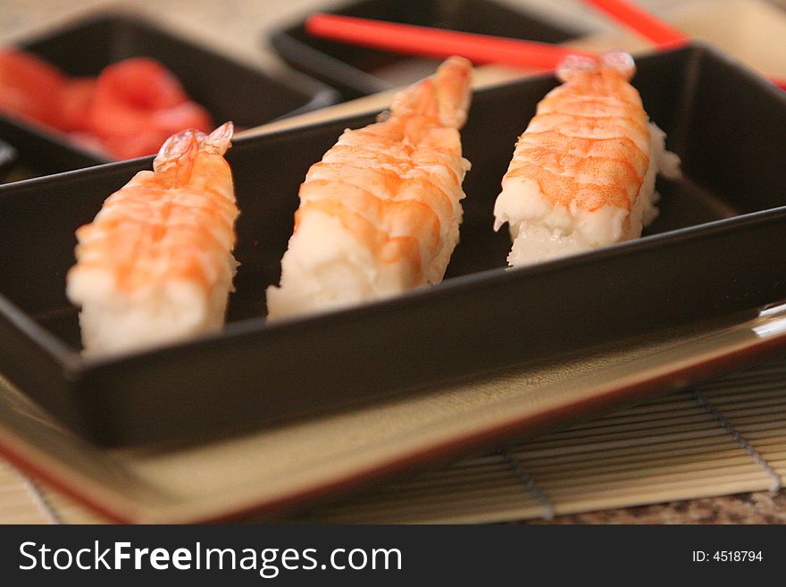 3 shrimp sushi in an elegant black tray. 3 shrimp sushi in an elegant black tray