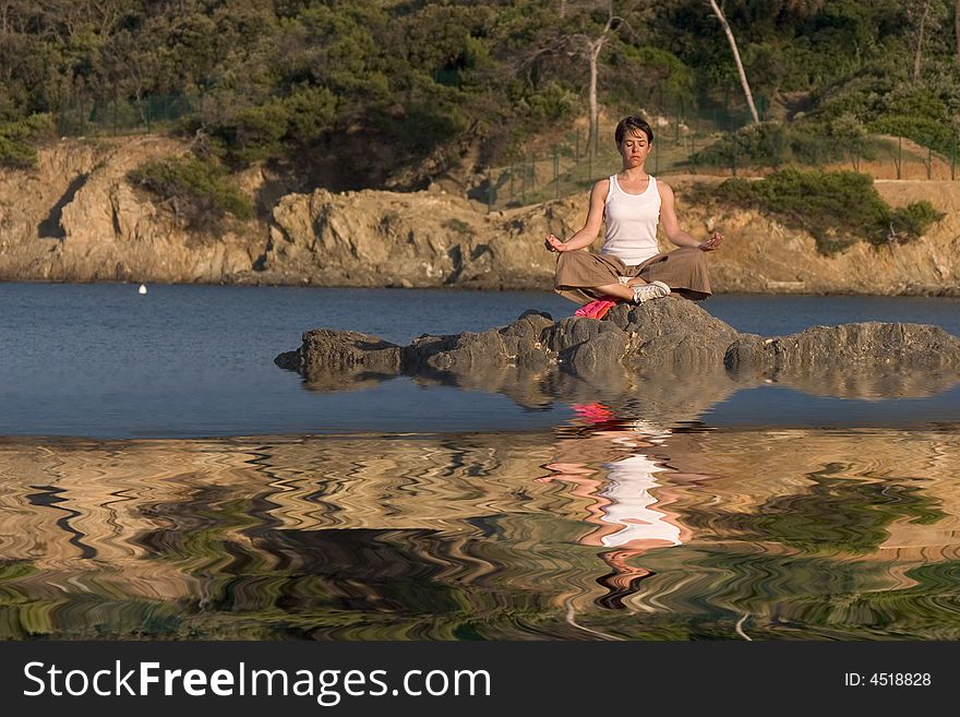 Woman making of yoga at the seaside. Woman making of yoga at the seaside