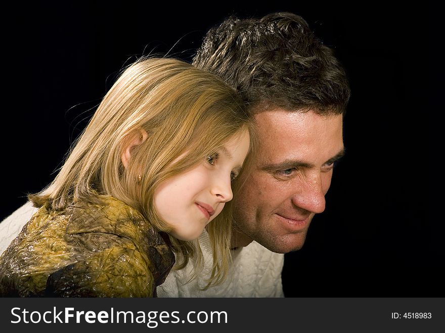 Happy father and his little pretty daughter on the black background. Happy father and his little pretty daughter on the black background