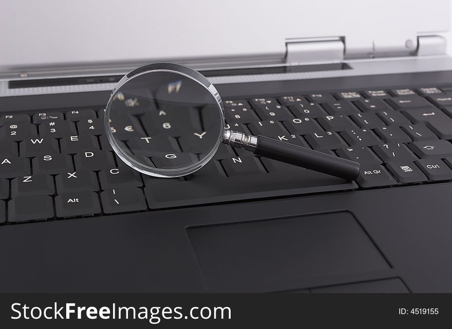 Laptop with a magnifying glass - security concept. Laptop with a magnifying glass - security concept