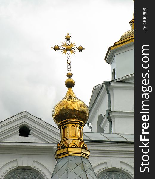 Church golden cupola with reach decorated cross