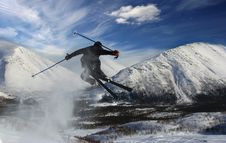 The Skier In Mountains In Flight From A Back Stock Photos