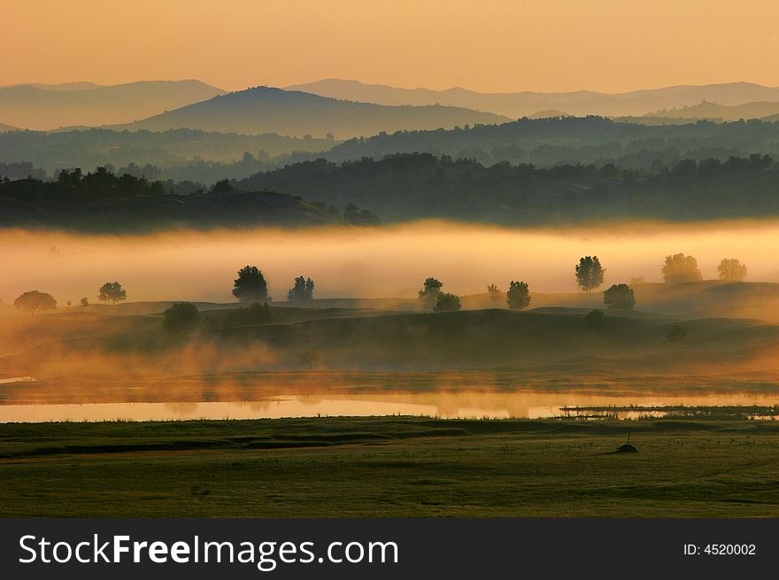 Heavy fog on the lake before sunrise