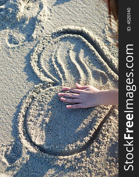 Heart figure drawn on the beach depicting love. Heart figure drawn on the beach depicting love