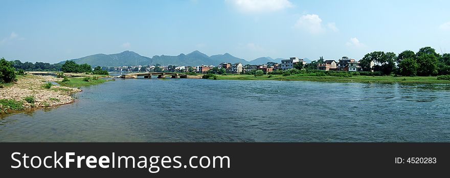 River, Town and Mountain under blue sky and white clouds, Guilin City, Guangxi, China