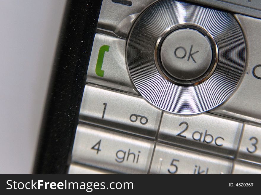 Close up of a mobile phone. Ok button in top right of image.