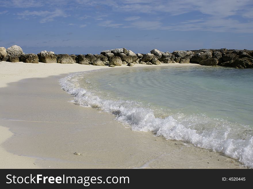 Rocks along beach cove in coco cay bahamas