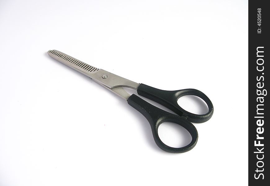 Haircutting scissors on white background