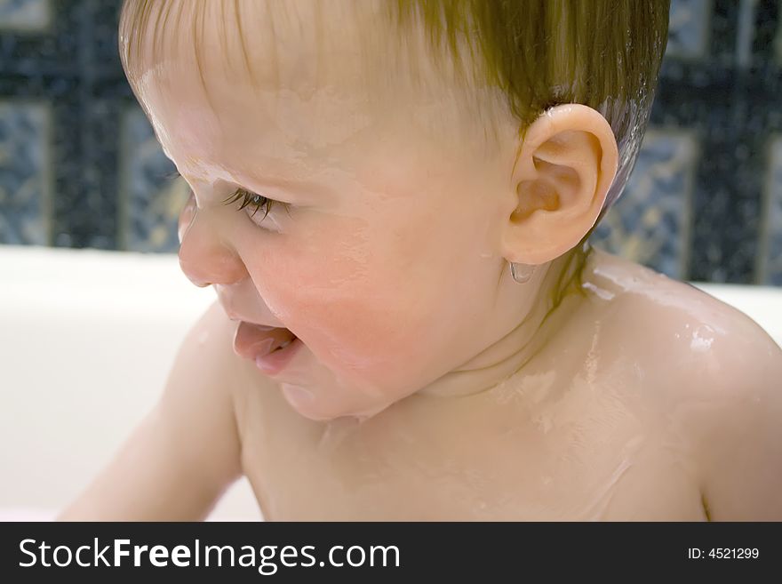 Bathing and smiling baby under the douche. Bathing and smiling baby under the douche