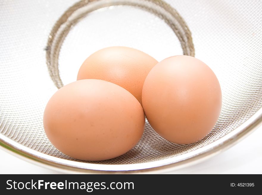 Three eggs on the metallic tray