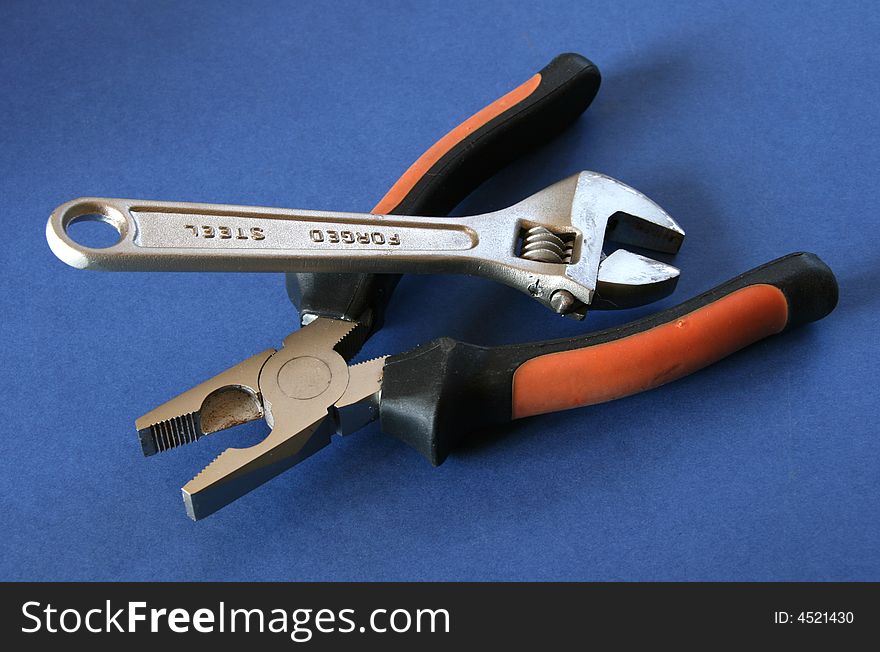 Two different tools over a blue background. Two different tools over a blue background