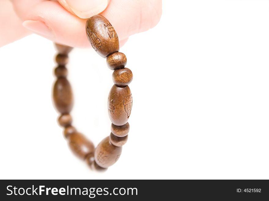 Rosary on woman hand over white isolated background