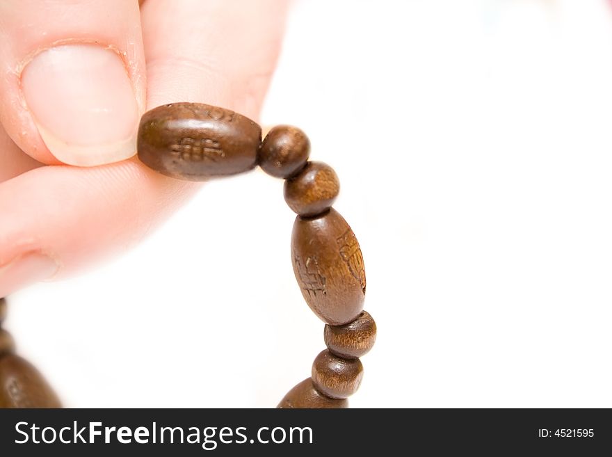 Rosary on woman hand over white isolated background