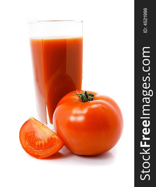 Fresh tomato fruits with juice in the glass isolated over white background. Fresh tomato fruits with juice in the glass isolated over white background