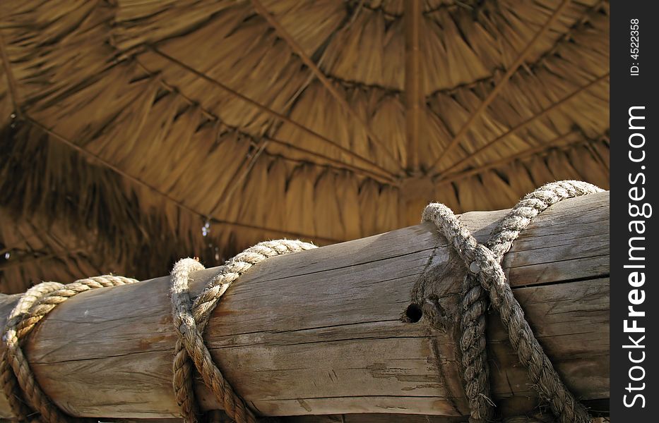 Bamboo fence and awning on a sea beach