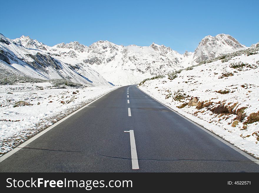 Beautiful winter panorama in the alps with an empty street. Beautiful winter panorama in the alps with an empty street