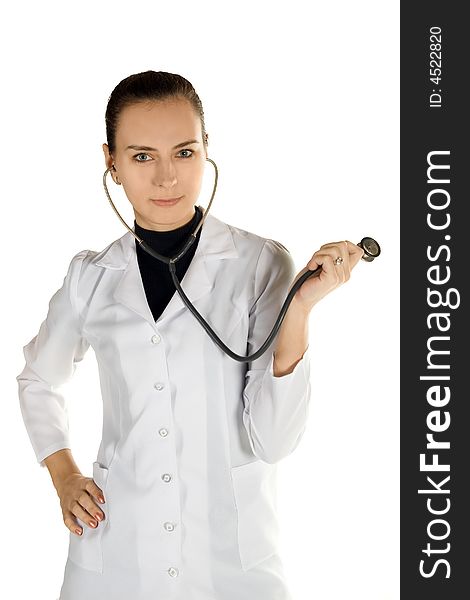 A young female doctor in a white cloak with a stethoscope.