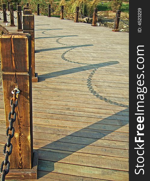 Shadow of handrails on a bridge