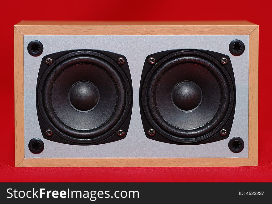 Small acoustic system on the red background. Small acoustic system on the red background.